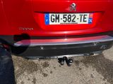 the rear end of a red car parked in a parking lot