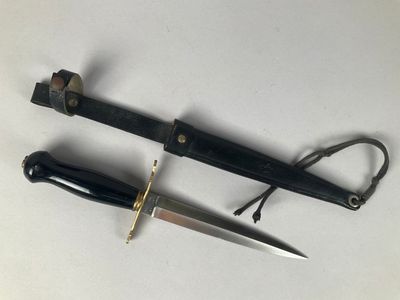 two knives that are laying next to each other on a table
