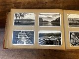 an open book with a bunch of pictures on it sitting on a table
