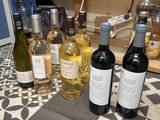 several bottles of wine are lined up on a counter top