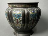 a silver vase with a multicolored design on it