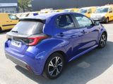 a blue car parked in a parking lot with other cars
