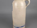 a white jug with a blue stripe on it