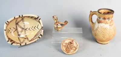 three pieces of pottery that are on display on a table
