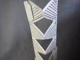 a paper sculpture of a tall tower with a clock on top of it