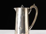 a silver coffee pot sitting on a white table