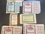 several old certificates are laid out on a table