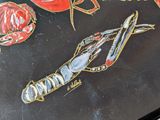 a painting of lobsters and crabs on a black surface