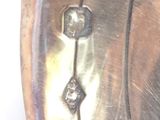 a close up of a metal object with a diamond on it