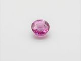a pink tourmaline gems on a white surface
