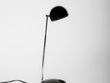 a black and white photo of a desk lamp and a mouse