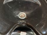 a black motorcycle with a black seat and a black sink