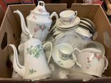 a box with a lot of tea and coffee set in it