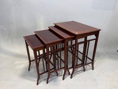 three wooden nesting tables on a white background with a white backdrop