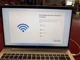 a laptop that has a wifi sign on the screen