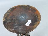 a rusted metal table with a tag on it