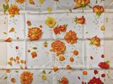 an image of a table cloth with orange roses on it