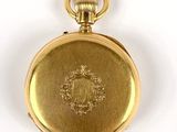 an image of a gold pocket watch on a white surface