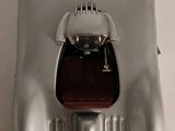a silver model of a car with a red seat