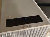 a white air conditioner sitting on top of a table