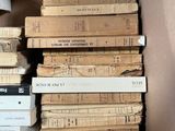 many books stacked on top of each other in a box