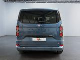 the rear end of a blue ford transit van parked in a garage