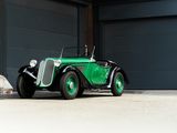 a green car parked in front of a garage door