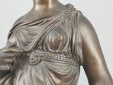 bronze statue of a woman holding a baby in her arms