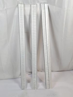 trois poteaux métalliques sur fond blanc et devant un fond blanc