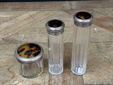 two salt and pepper shakers sitting on a wooden table