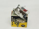 a toy scooter in a box on a white surface