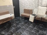 two chairs and a table in a room with a brick wall