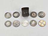a lot of coins that are on a white surface
