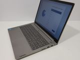 the laptop is sitting on the table with the screen open
