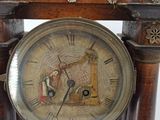 a clock that is sitting on top of a wooden stand