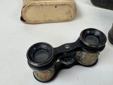 an old pair of binoculars sitting on top of a table next to a book