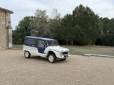 a white and blue jeep parked in front of a building