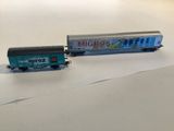 a toy train that is sitting next to a toy truck