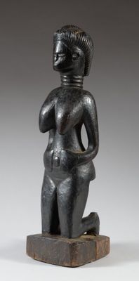 a black statue of a woman with her hands in her pockets