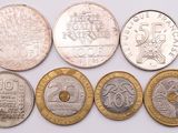 six different types of coins are shown on a white surface