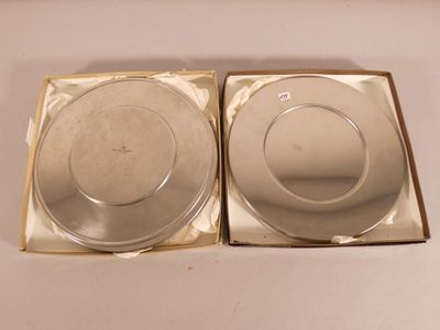 pair of silver plates in a box on a white surface