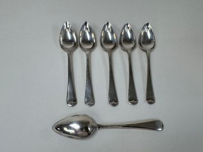 five spoons and a spoon on a white table