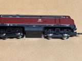 a red and black train on the tracks on a table