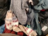 a pile of clothes that is sitting on the floor