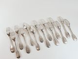 a lot of forks and spoons on a white table