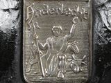a metal plaque with a picture of a man on a horse