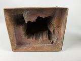an old rusted metal box with a hole in it