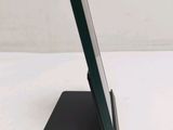 a cell phone that is on a stand on a table