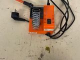 a small orange machine that is sitting on a table