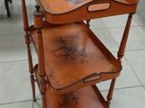 a wooden table with three trays on top of it